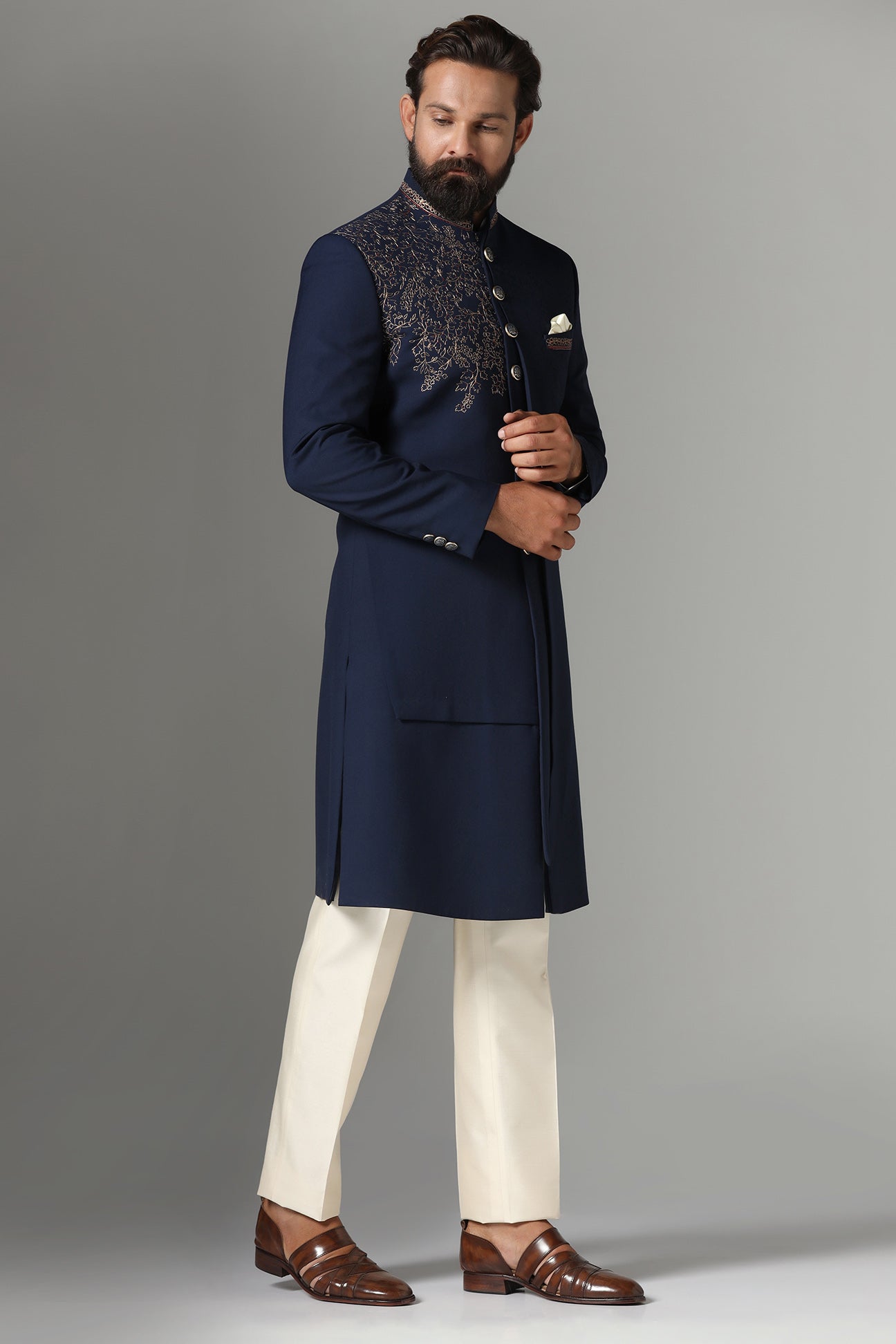 This navy blue Indo-western features golden embroidery on the collar and right panel. Shop Now!