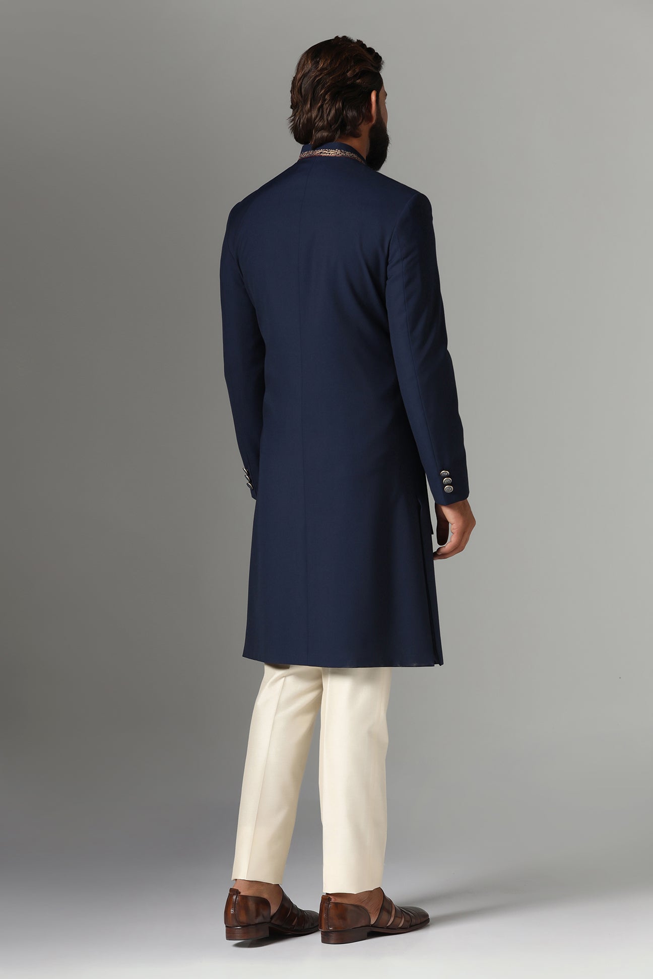This navy blue Indo-western features golden embroidery on the collar and right panel. Shop Now!