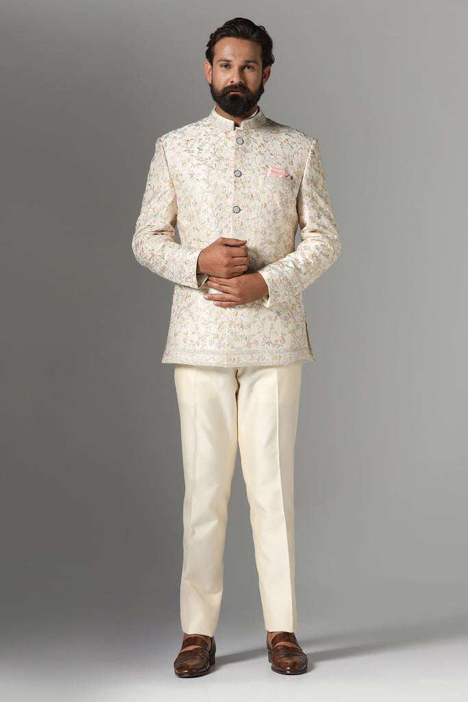 Exude sophistication in our off-white Bandhgala suit crafted from wool-rich fabric. Tonal embroidery adorns the garment, paired with matching off-white churidar trousers for a timeless look.