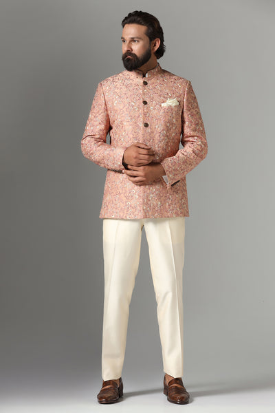 Dress in sophistication with our light orange Bandhgala suit, adorned with intricate embroidery. Complete with matching off-white trousers for a polished ensemble.