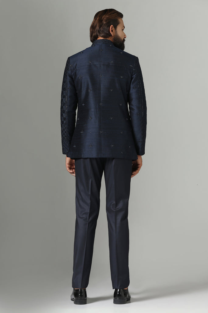 Elevate your style with our Navy blue Bandhgala suit, adorned with delicate embroidery. Complete with Polo trousers for a refined ensemble.