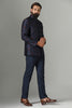 Exude elegance in our Navy Blue Bandhgala suit crafted from Raw-Silk fabric, adorned with floral embroidery. Paired with monochrome navy blue trousers for a sophisticated look.