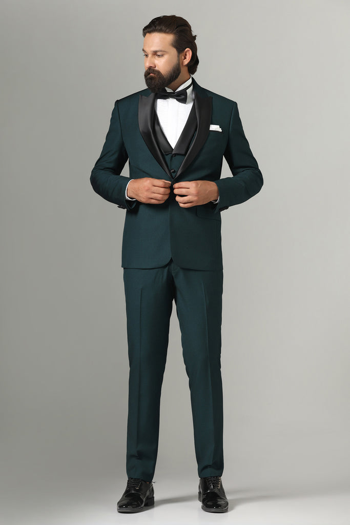 Elevate your style with our Bottle Green Tuxedo. Notched lapel, single-button closure. Paired with matching waistcoat and trousers for a polished look.