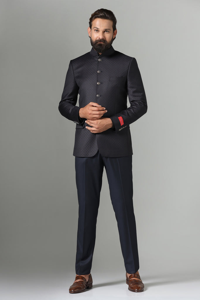 "Refined style meets functionality in our black Bandhgala Suit, tailored from all-weather wool-rich fabric. Contemporary design with sharp cut, double vents, and 6-button closure.