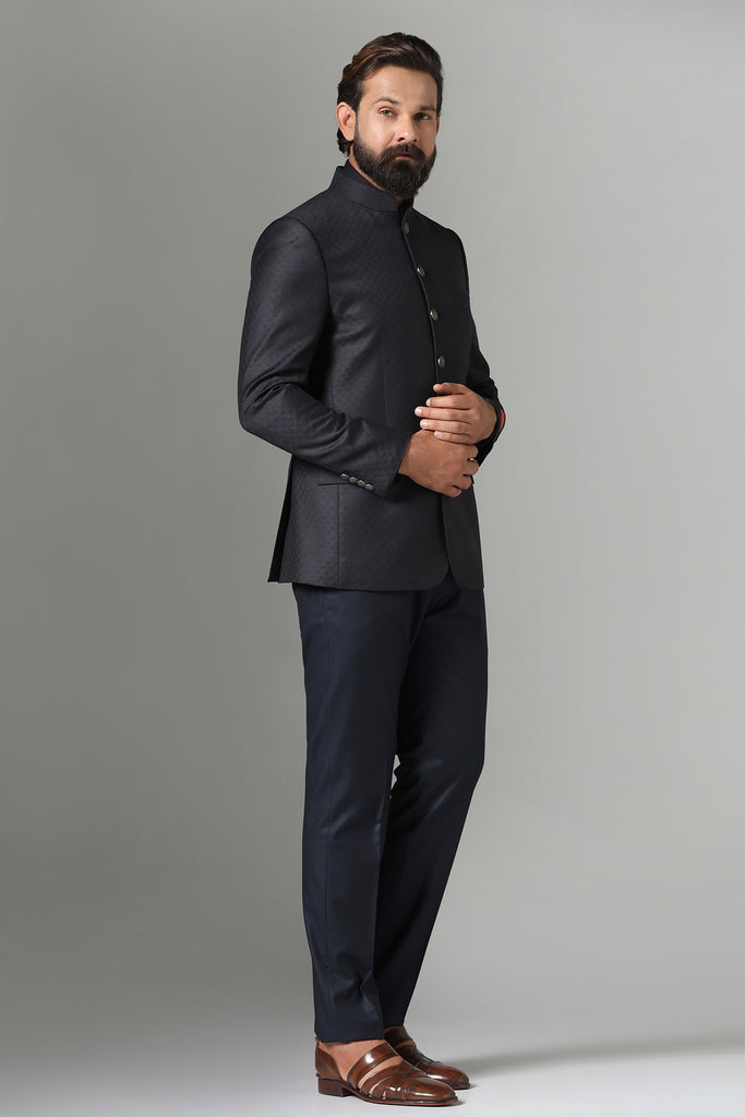 "Refined style meets functionality in our black Bandhgala Suit, tailored from all-weather wool-rich fabric. Contemporary design with sharp cut, double vents, and 6-button closure.