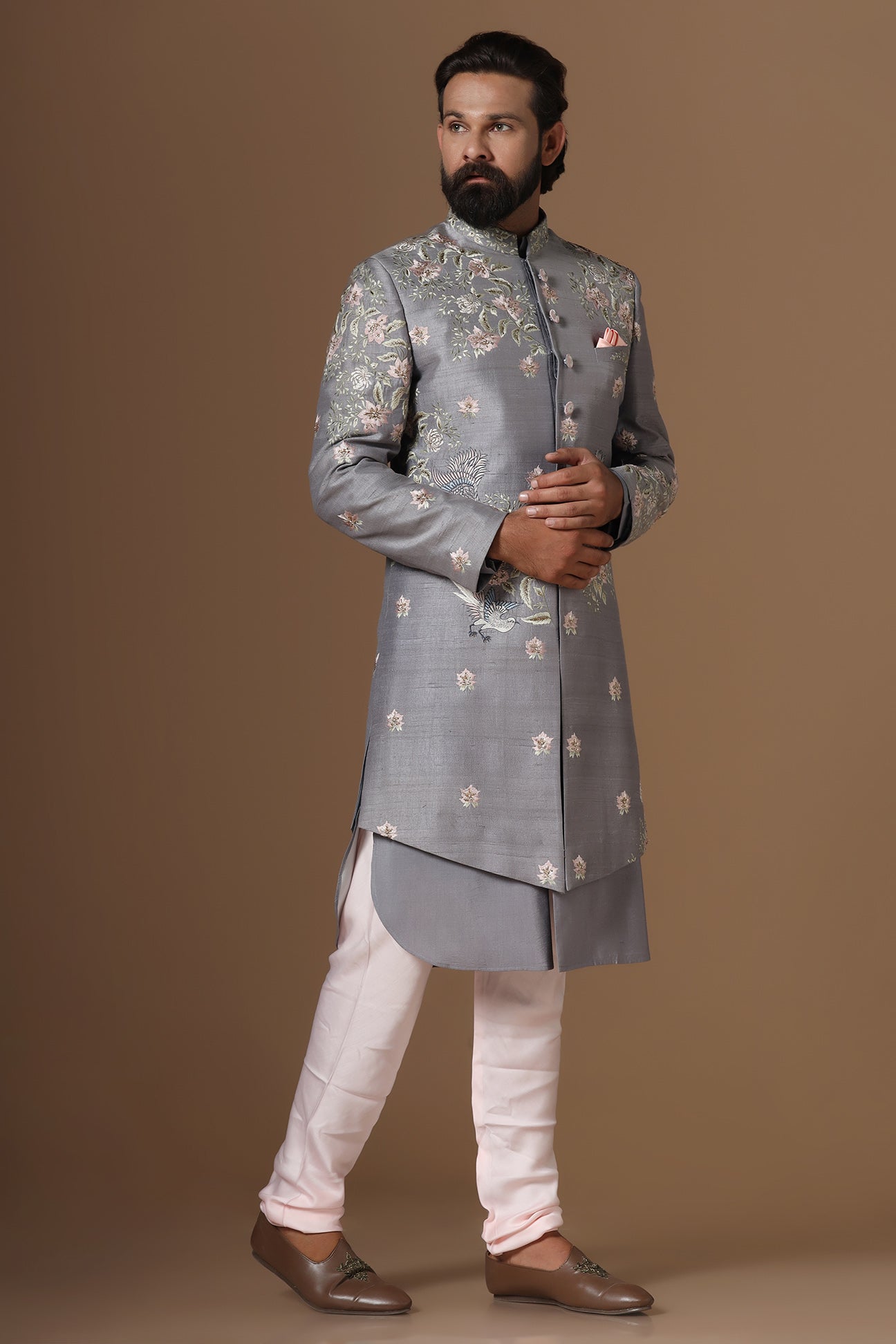 This grey Indowestern is highlighted with floral motif embroidery. Shop Now!