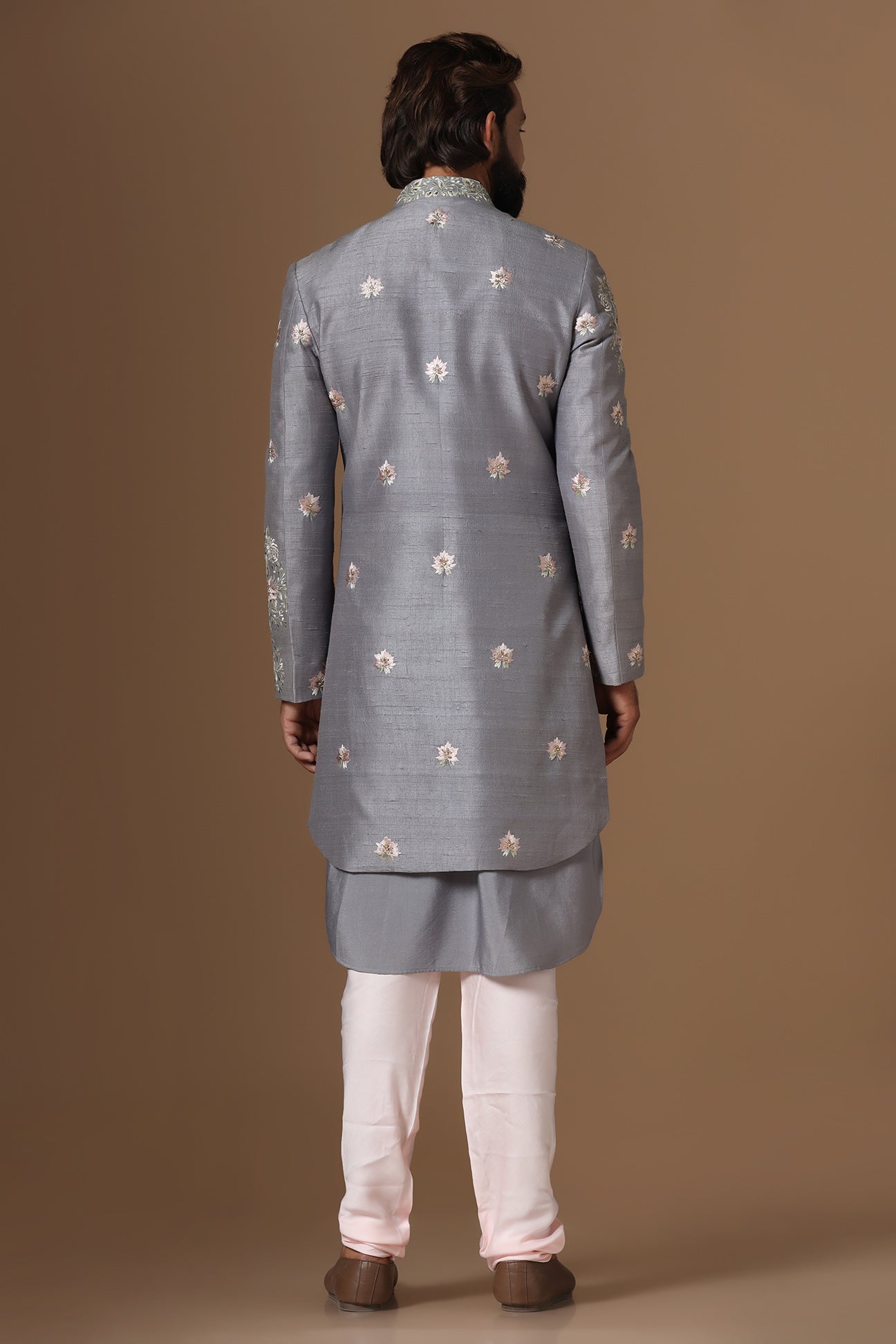 This grey Indowestern is highlighted with floral motif embroidery. Shop Now!