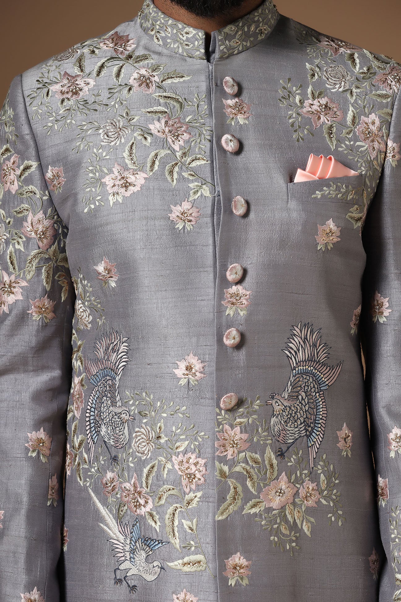 This grey Indowestern is highlighted with floral motif embroidery. Shop Now!