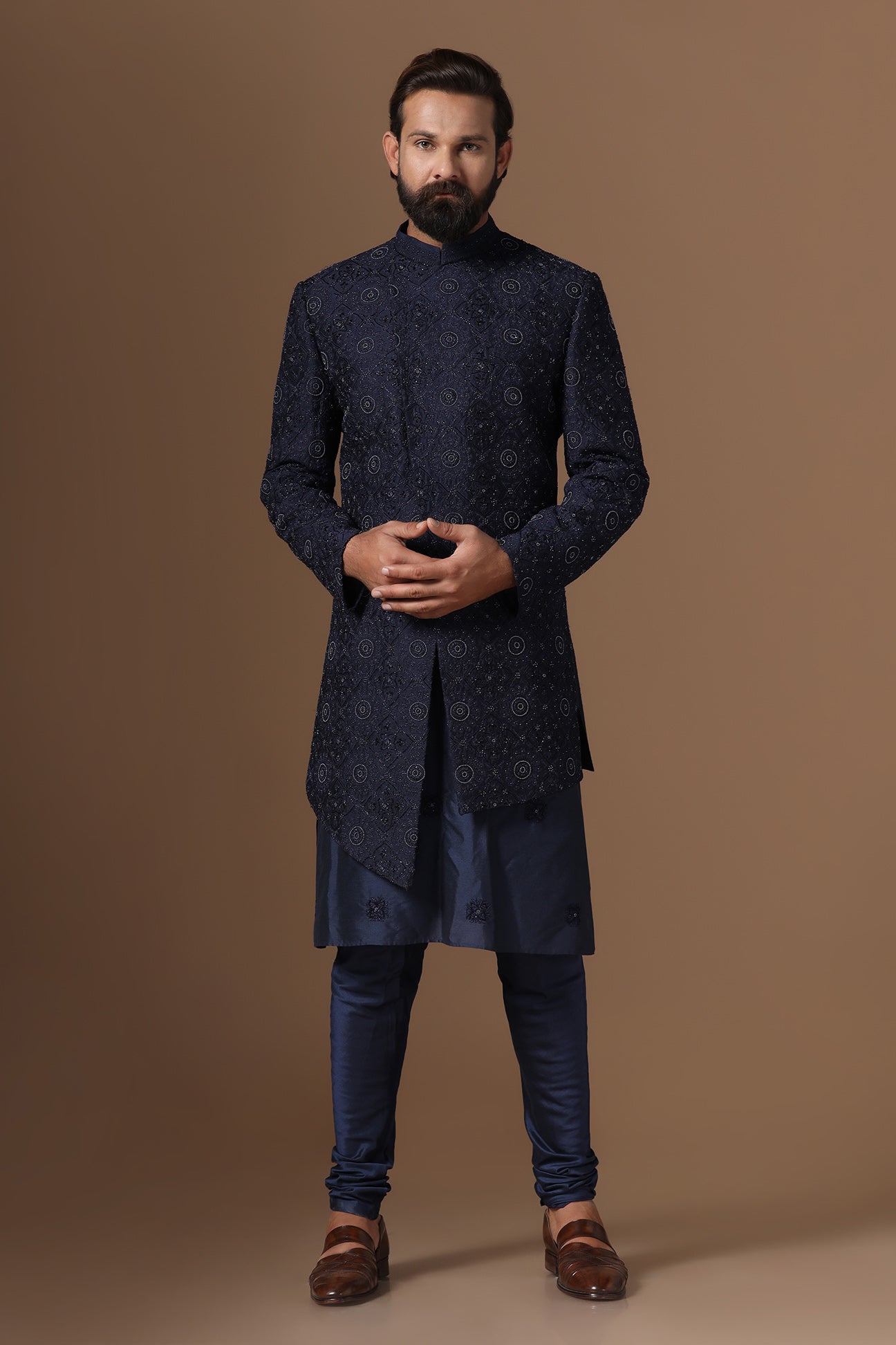 This asymmetric navy blue Indowestern is highlighted with embroidery. Shop Now!