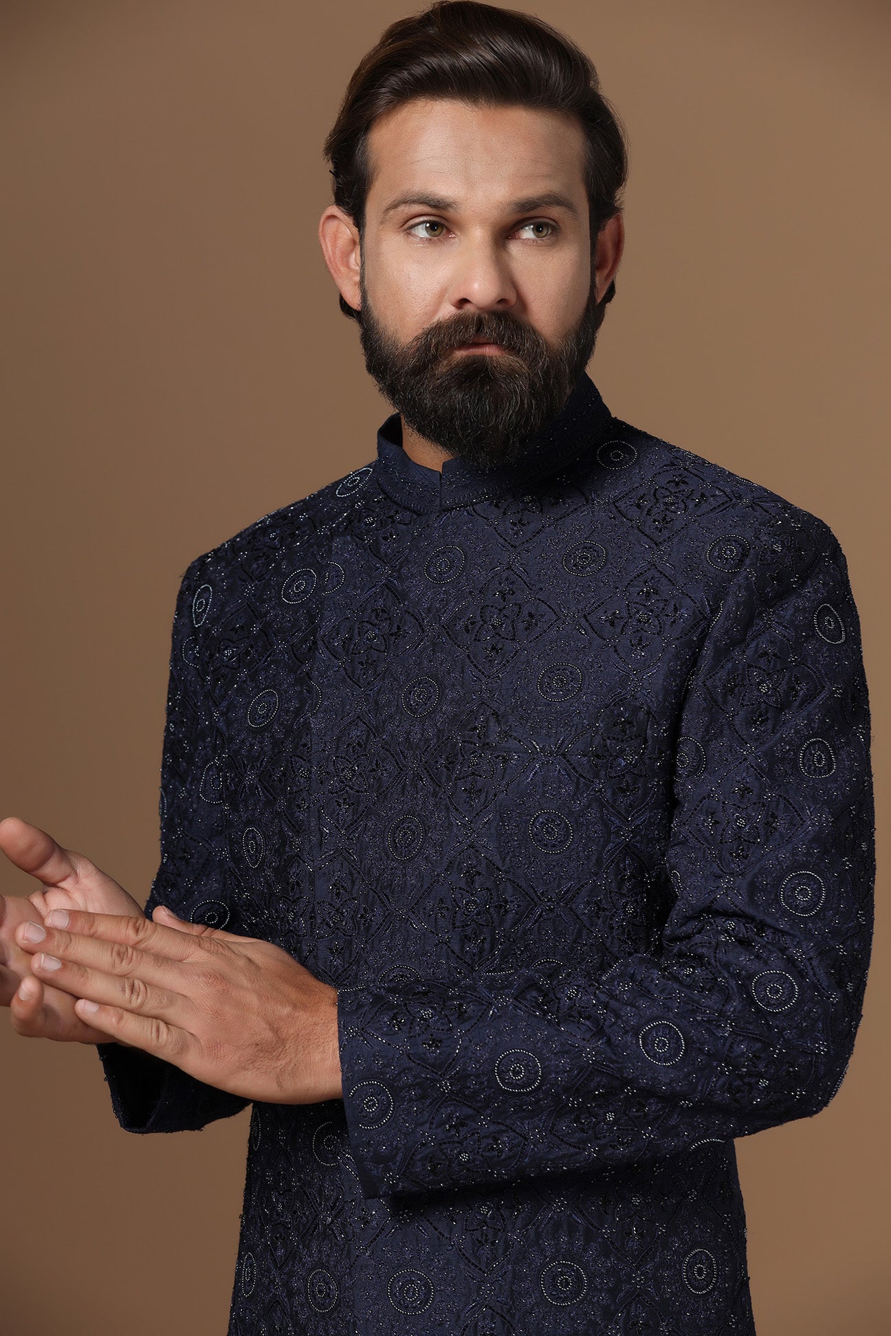 This asymmetric navy blue Indowestern is highlighted with embroidery. Shop Now!