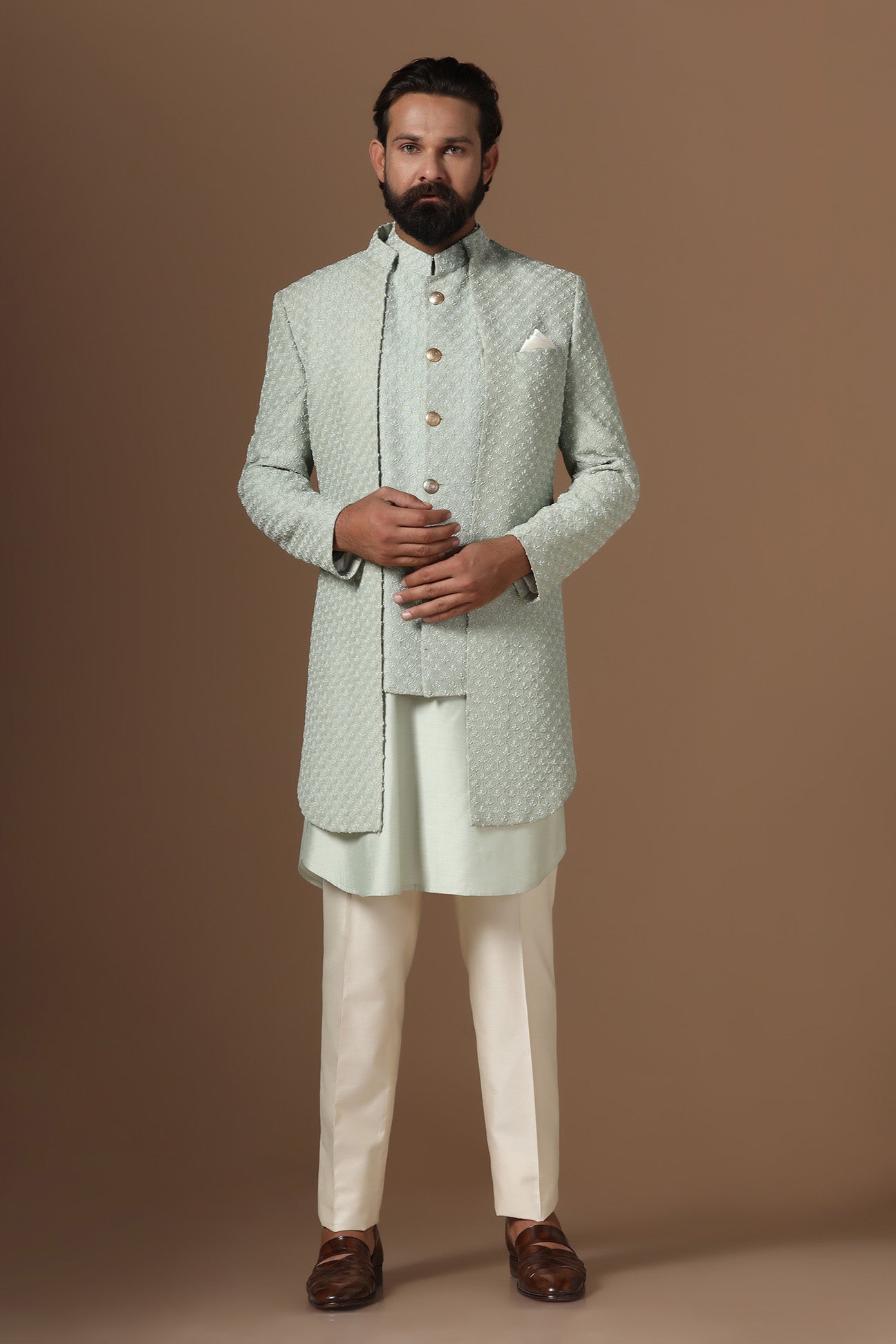 This pistachio green Indowestern is highlighted with overall embroidery across the body. Shop Now!