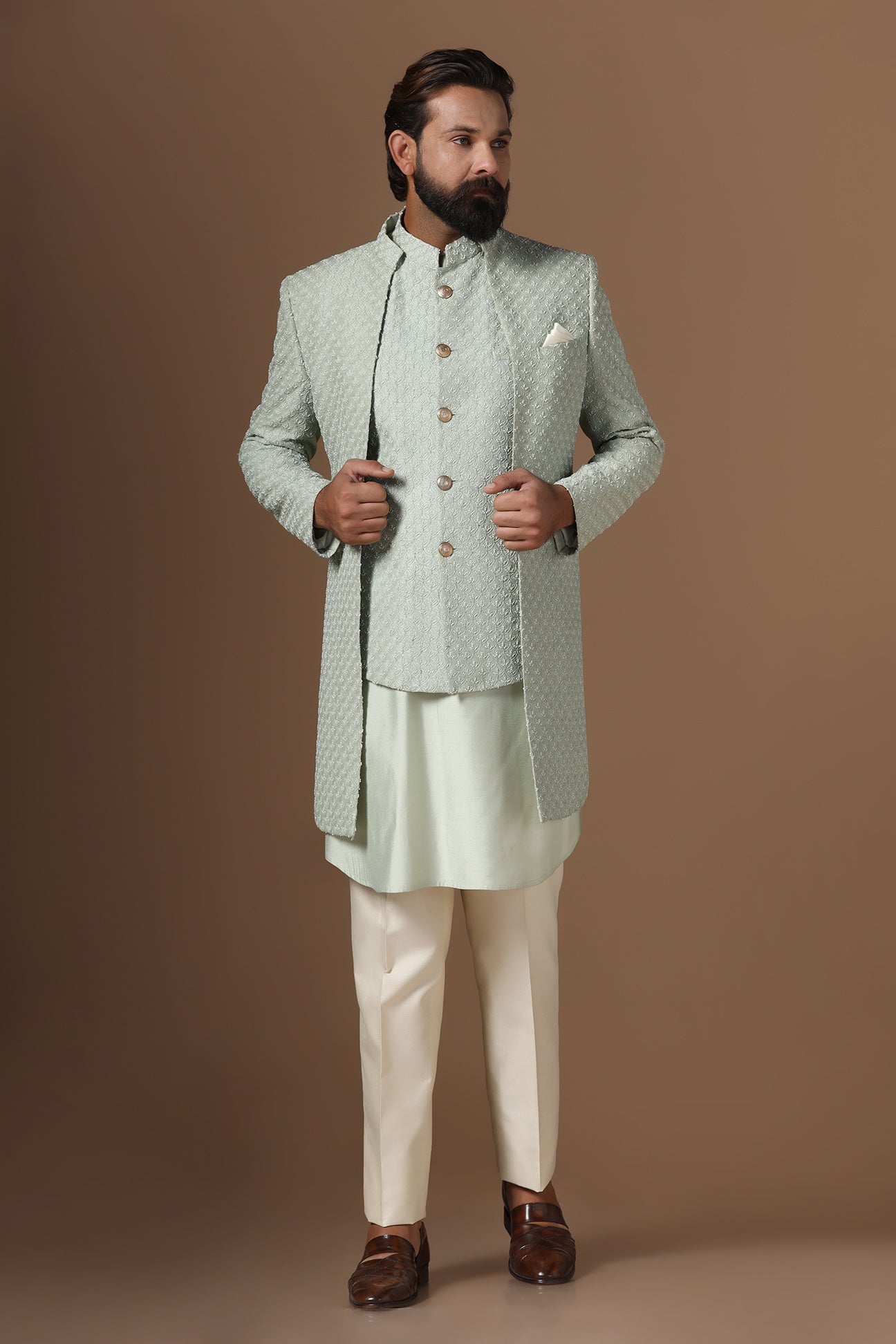 This pistachio green Indowestern is highlighted with overall embroidery across the body. Shop Now!