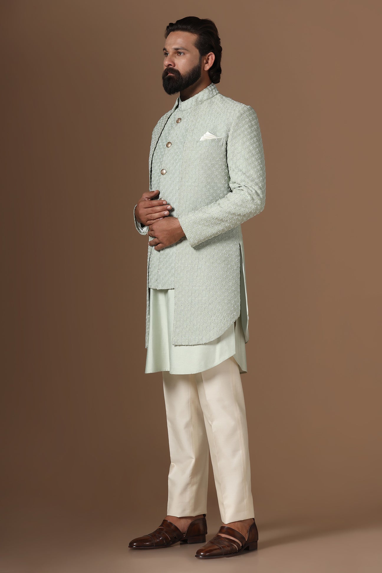 This pistachio green Indowestern is highlighted with overall embroidery across the body. Shop Now!