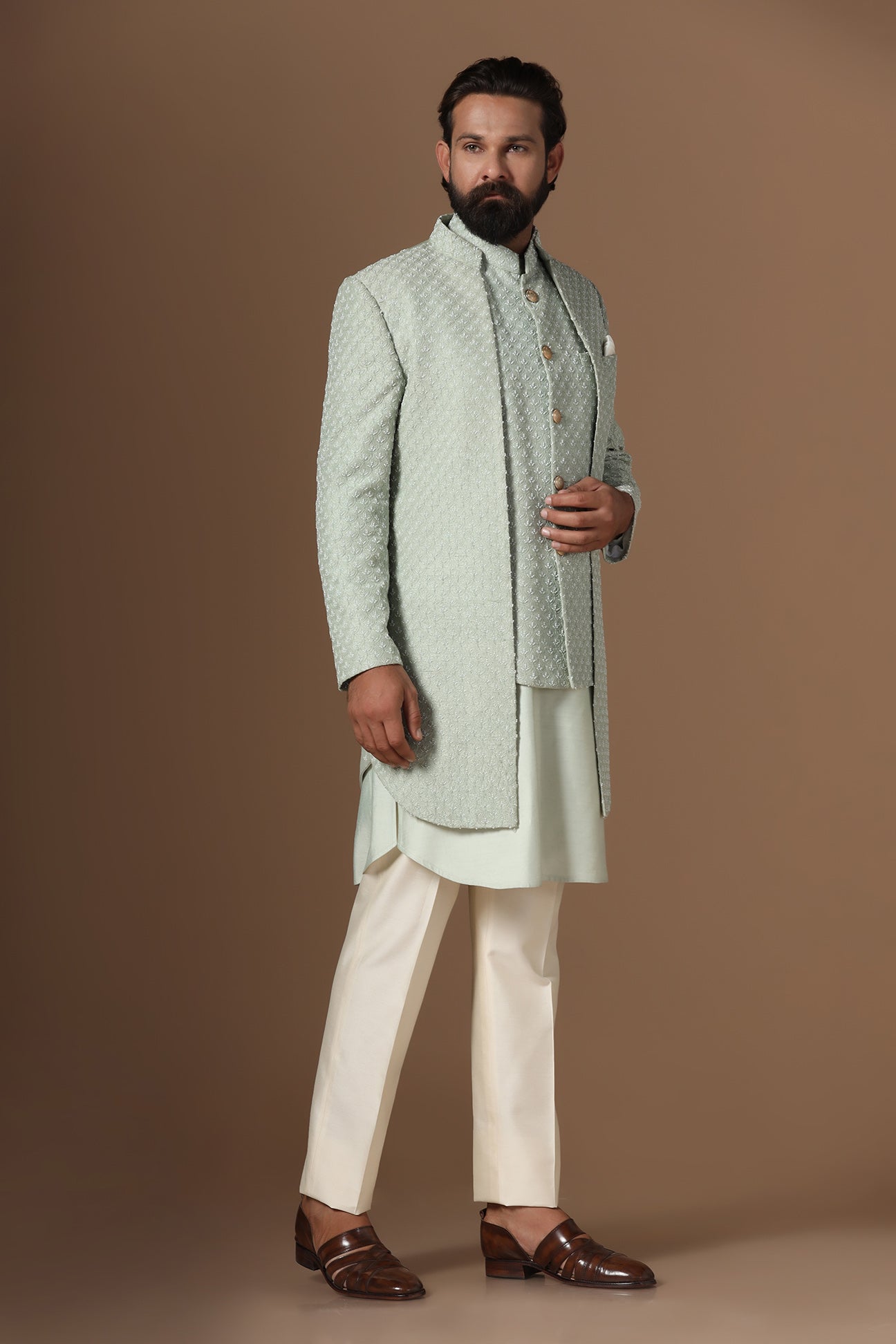 This pistachio green Indowestern is highlighted with overall embroidery across the body. Shop Now!