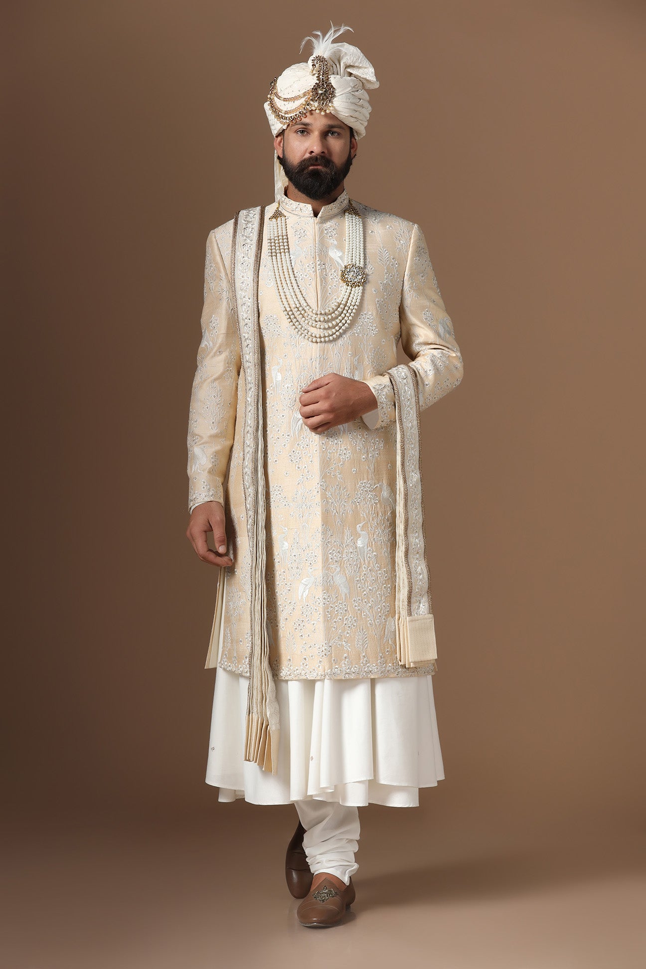 Elevate your style with our beige sherwani with intricate floral and bird embroidery. Shop Now!