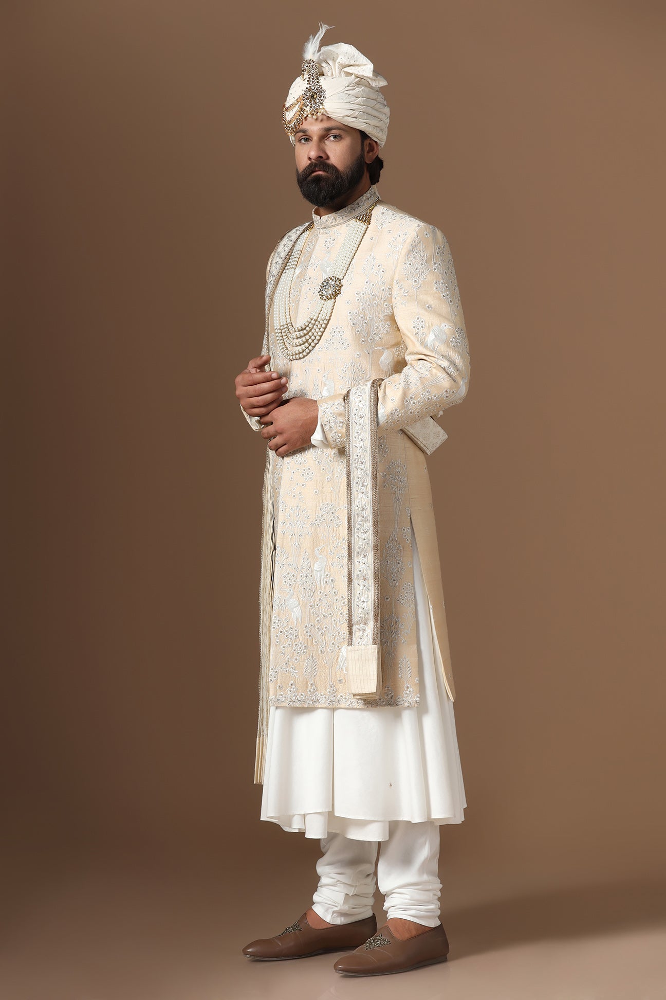 Elevate your style with our beige sherwani with intricate floral and bird embroidery. Shop Now!