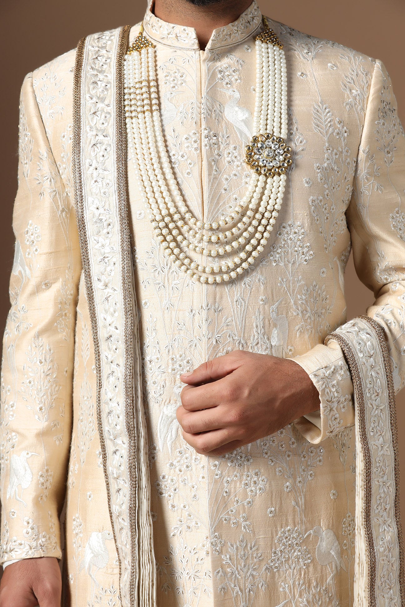Elevate your style with our beige sherwani with intricate floral and bird embroidery. Shop Now!