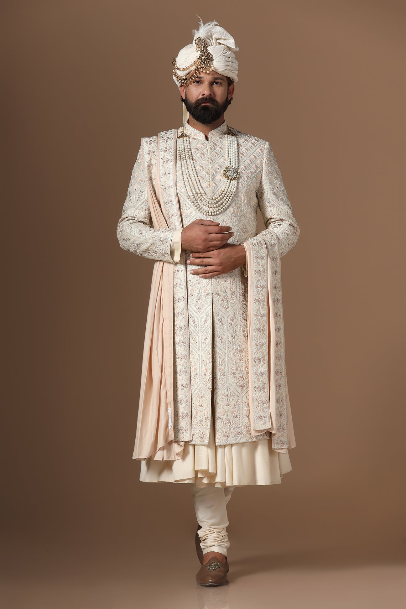 Indulge in elegance with our beige Sherwani with floral and geometric embroidery. Shop Now!