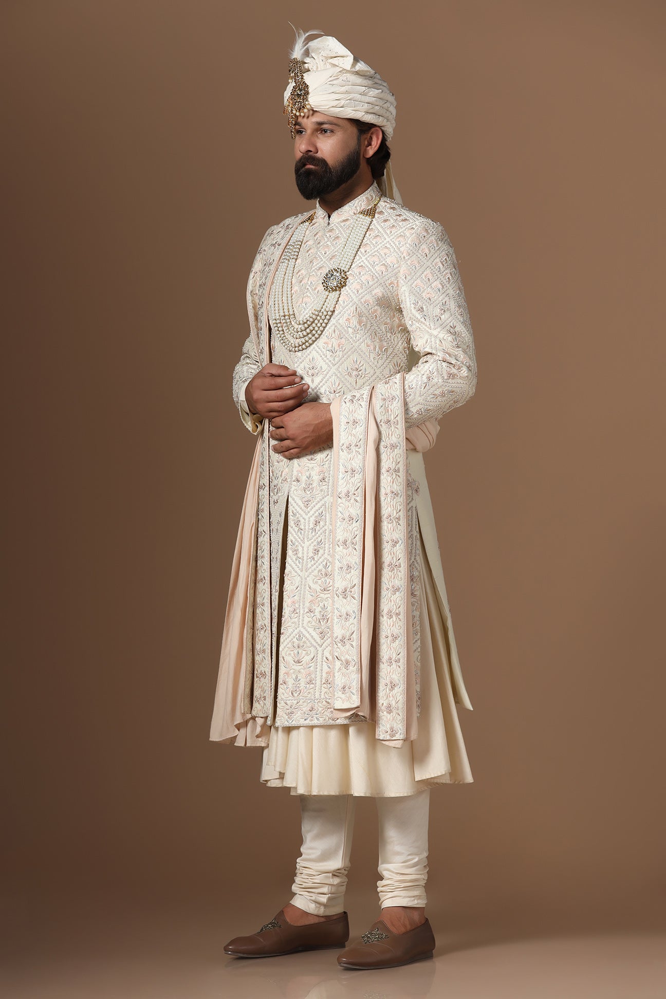 Indulge in elegance with our beige Sherwani with floral and geometric embroidery. Shop Now!