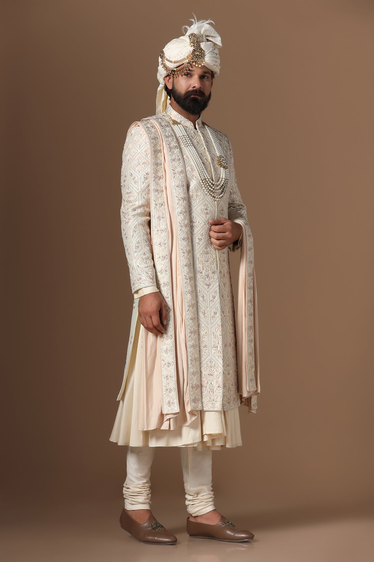 Indulge in elegance with our beige Sherwani with floral and geometric embroidery. Shop Now!