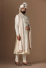 Indulge in elegance with our beige Sherwani, adorned with floral and geometric embroidery. Paired with a pleated kurta and pajama set for a refined look.