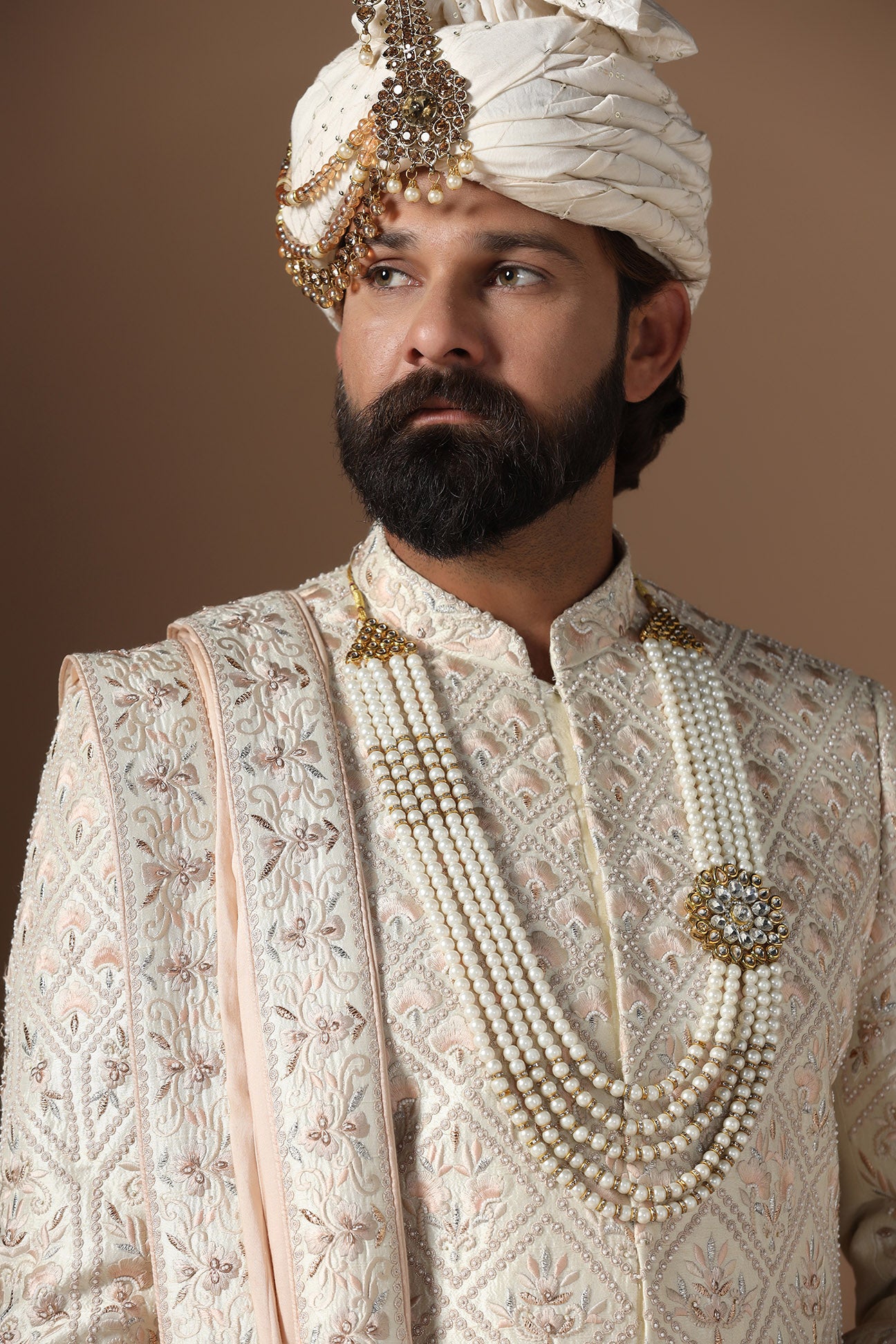 Indulge in elegance with our beige Sherwani with floral and geometric embroidery. Shop Now!