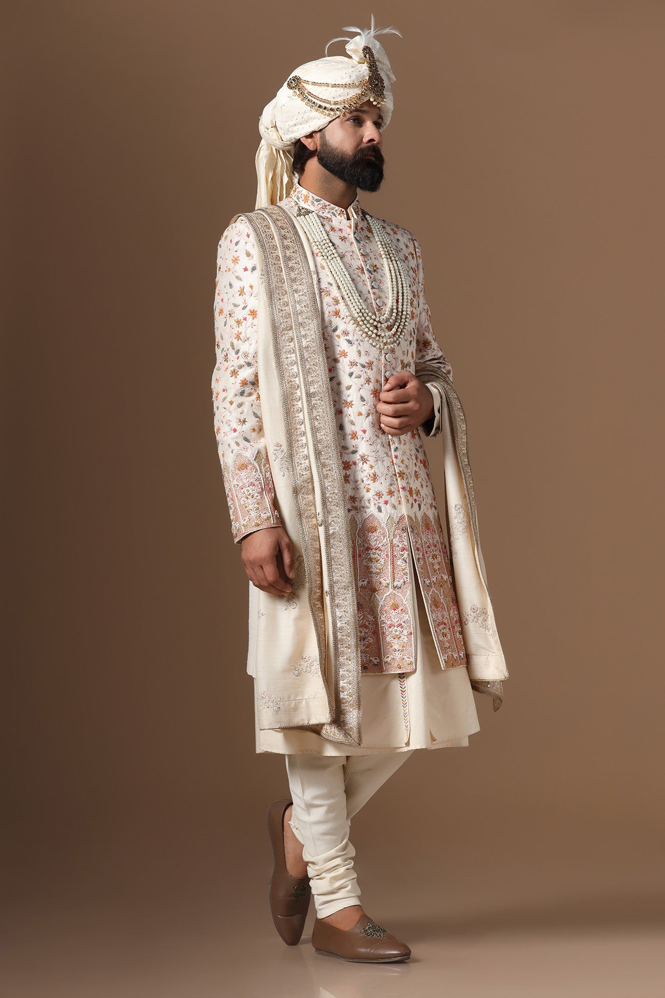 Indulge in elegance with our beige Sherwani with floral and geometric embroidery. Shop Now!