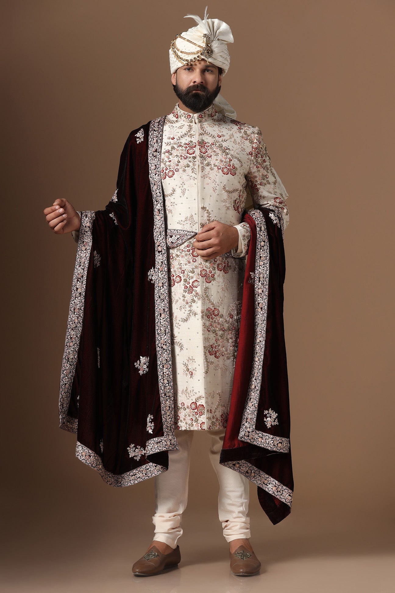 This beige sherwani is highlighted with floral embroidery patterns. Shop Now!