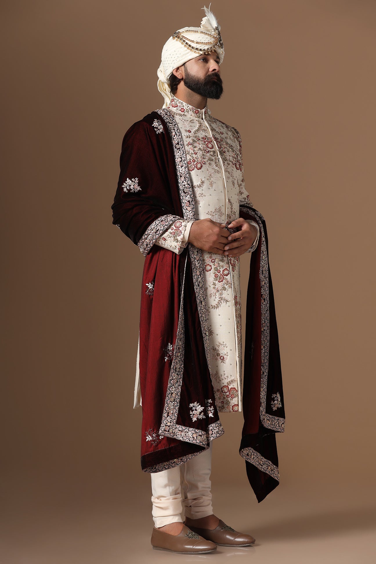 This beige sherwani is highlighted with floral embroidery patterns. Shop Now!