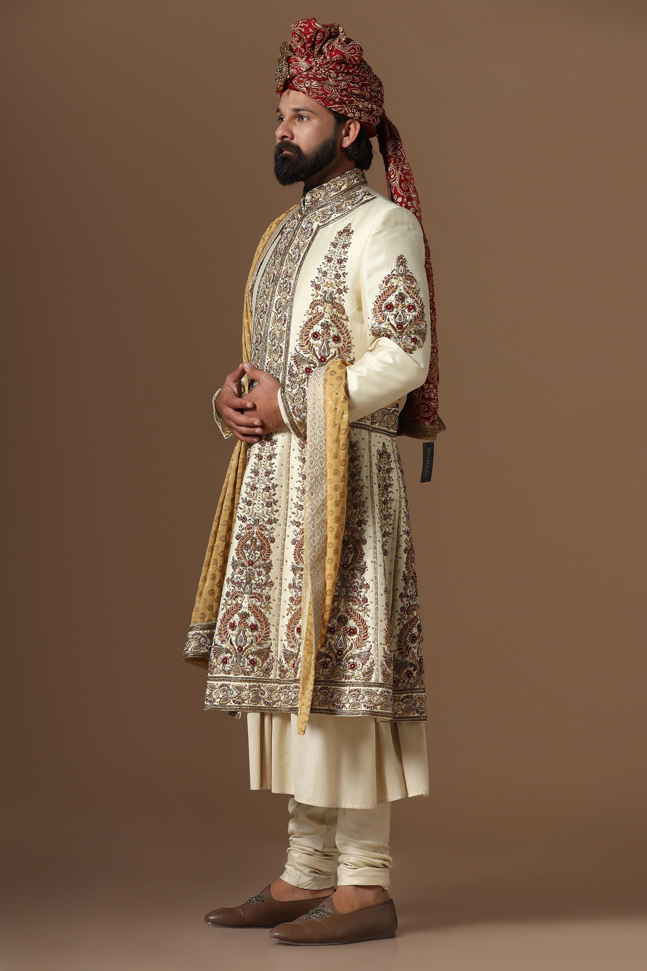 This Off-White Sherwani is highlighted by floral embroidery. Shop Now!