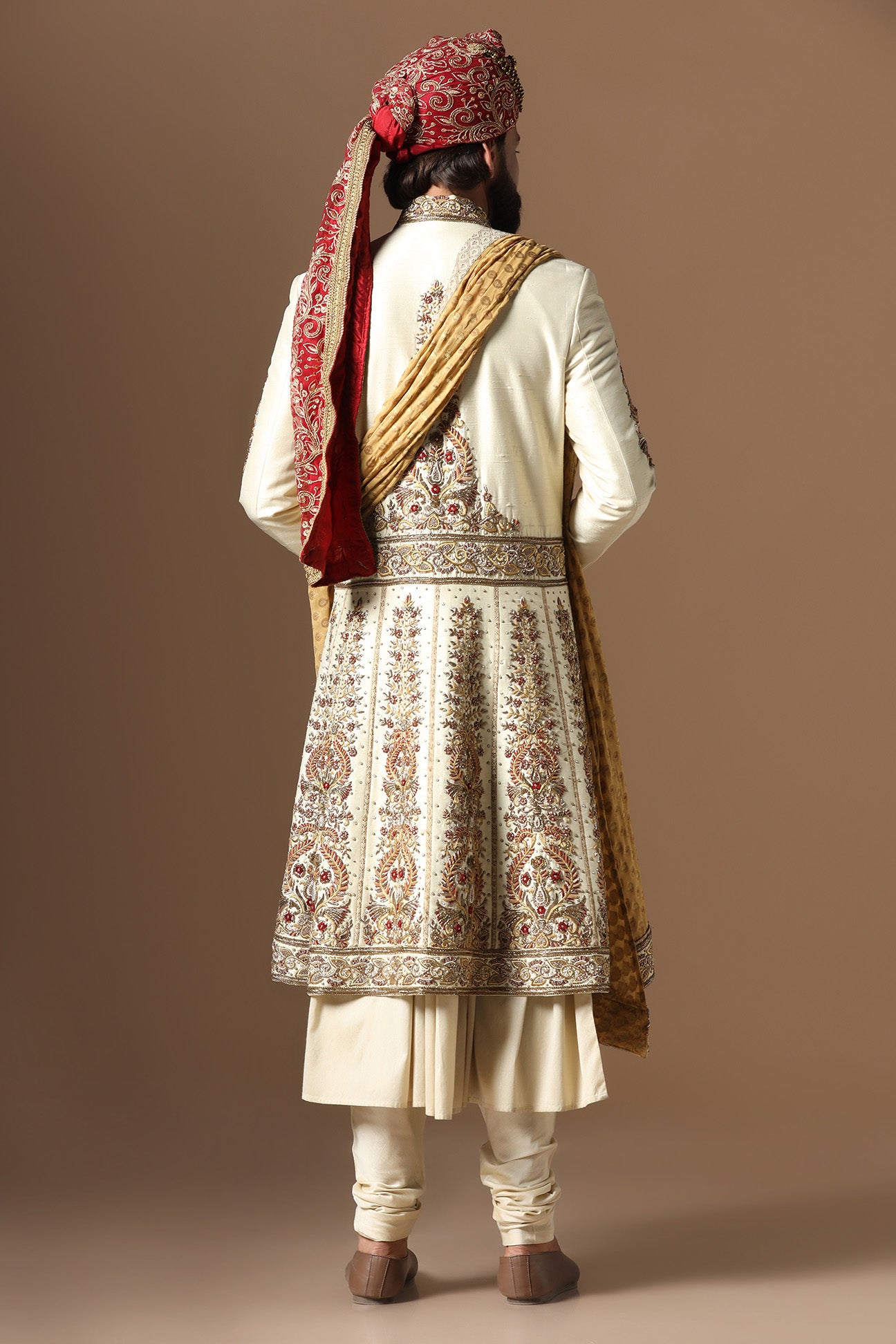 This Off-White Sherwani is highlighted by floral embroidery. Shop Now!