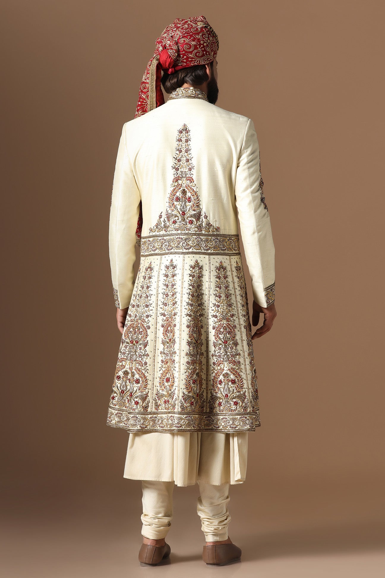 This Off-White Sherwani is highlighted by floral embroidery. Shop Now!
