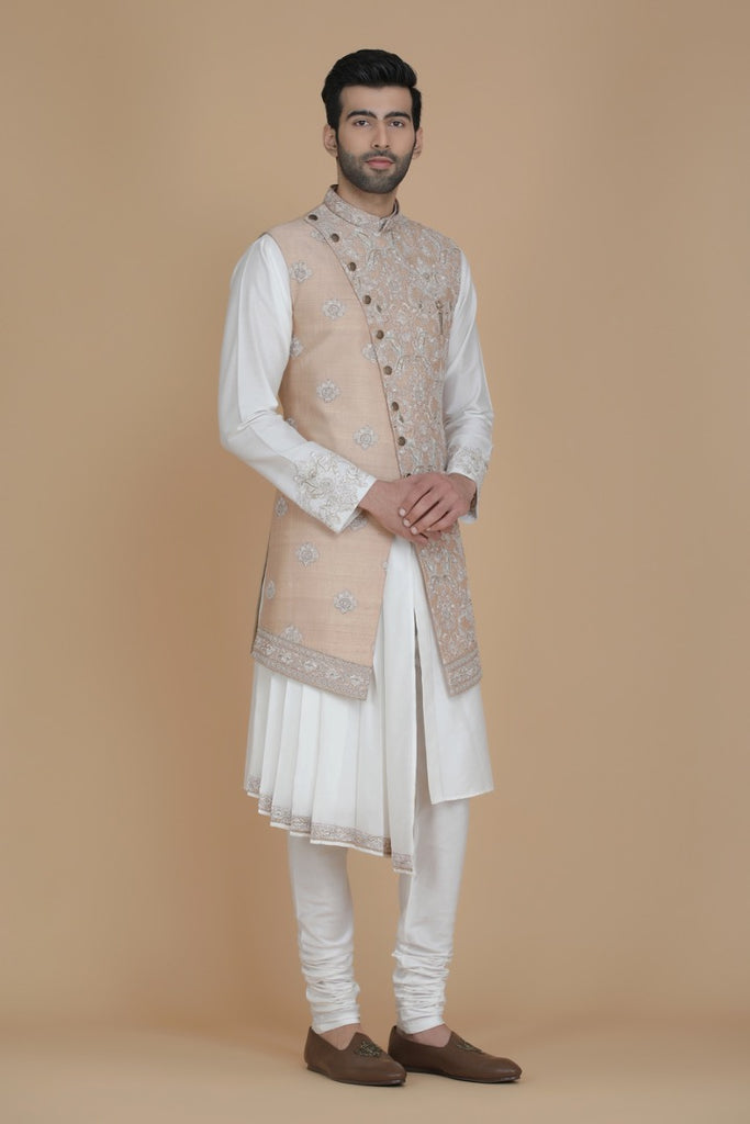 Step into sophistication with our long Nehru jacket featuring paneled embroidery. Paired with a draped kurta and pajama for an elegant ensemble.