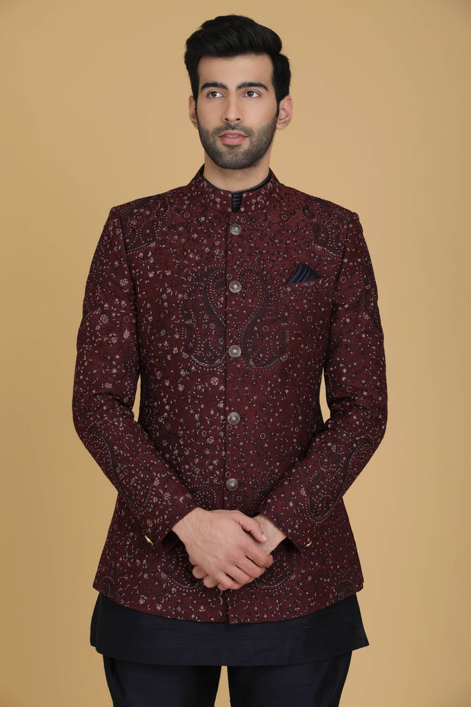 Elevate your style with our Maroon Bandhgala suit, adorned with delicate embroidery. Complete with a short kurta and Polo trousers for a refined ensemble.