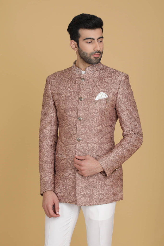 Dress in elegance with our Peach Bandhgala suit adorned with delicate embroidery. Paired with narrow trousers for a refined ensemble.