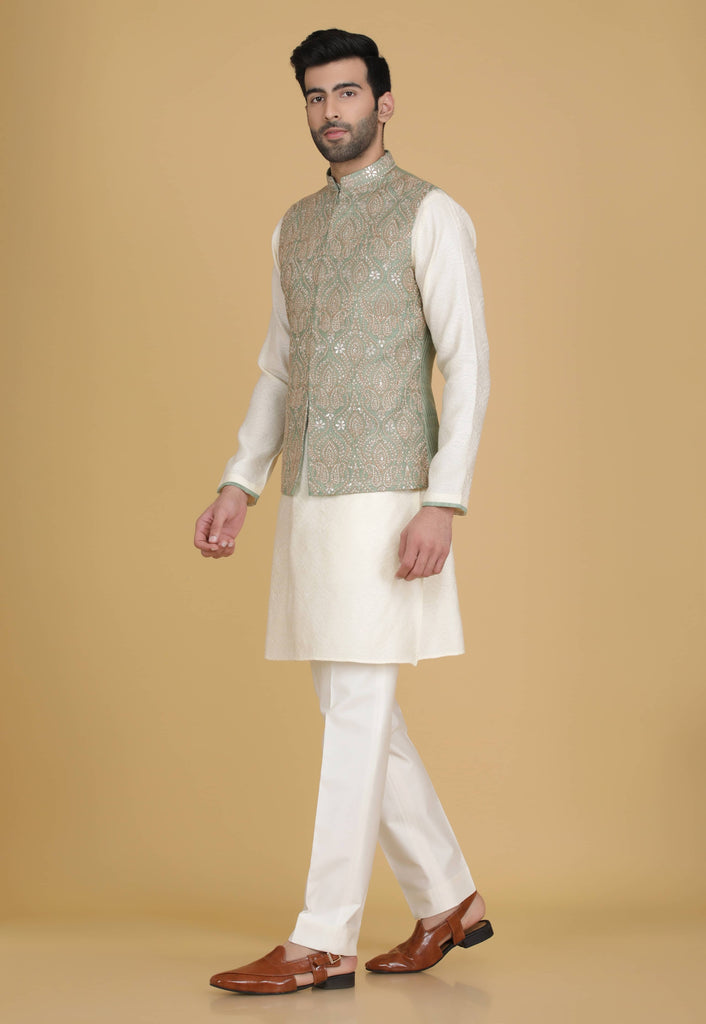 Embrace elegance in our Nehru jacket adorned with delicate embroidery. Paired with a short kurta and pajama set for a refined ensemble.