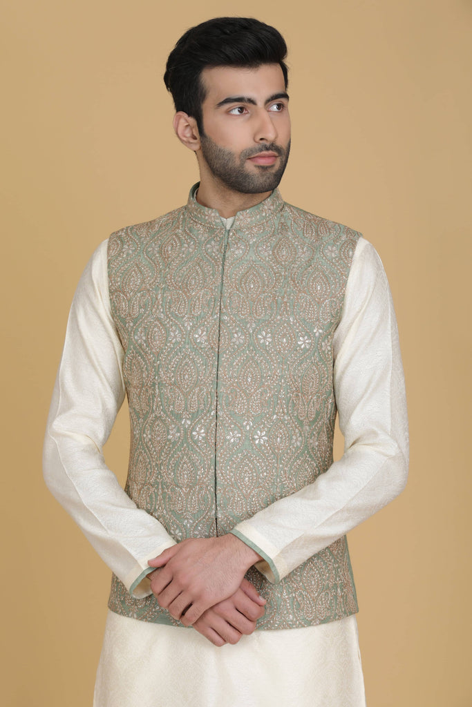 Embrace elegance in our Nehru jacket adorned with delicate embroidery. Paired with a short kurta and pajama set for a refined ensemble.