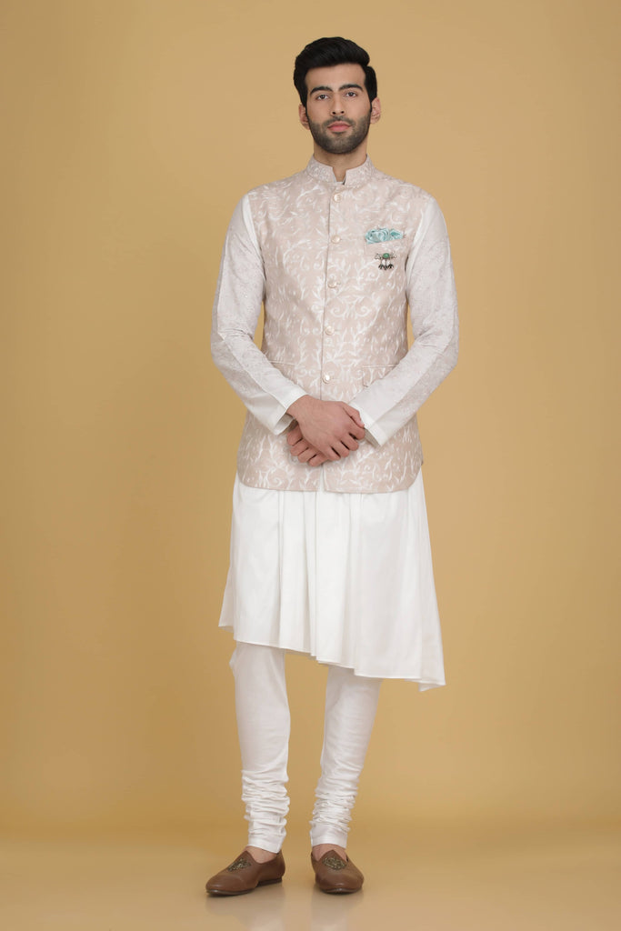 Elevate your style with our Nehru jacket featuring intricate thread embroidery. Paired with a draped kurta and pajama set for a complete ensemble.