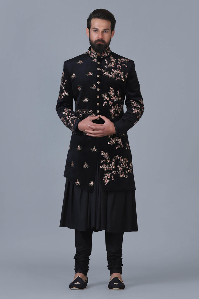 Exude sophistication in our black velvet Indowestern, adorned with intricate floral embroidery. Perfectly paired with a matching black kurta pajama set.