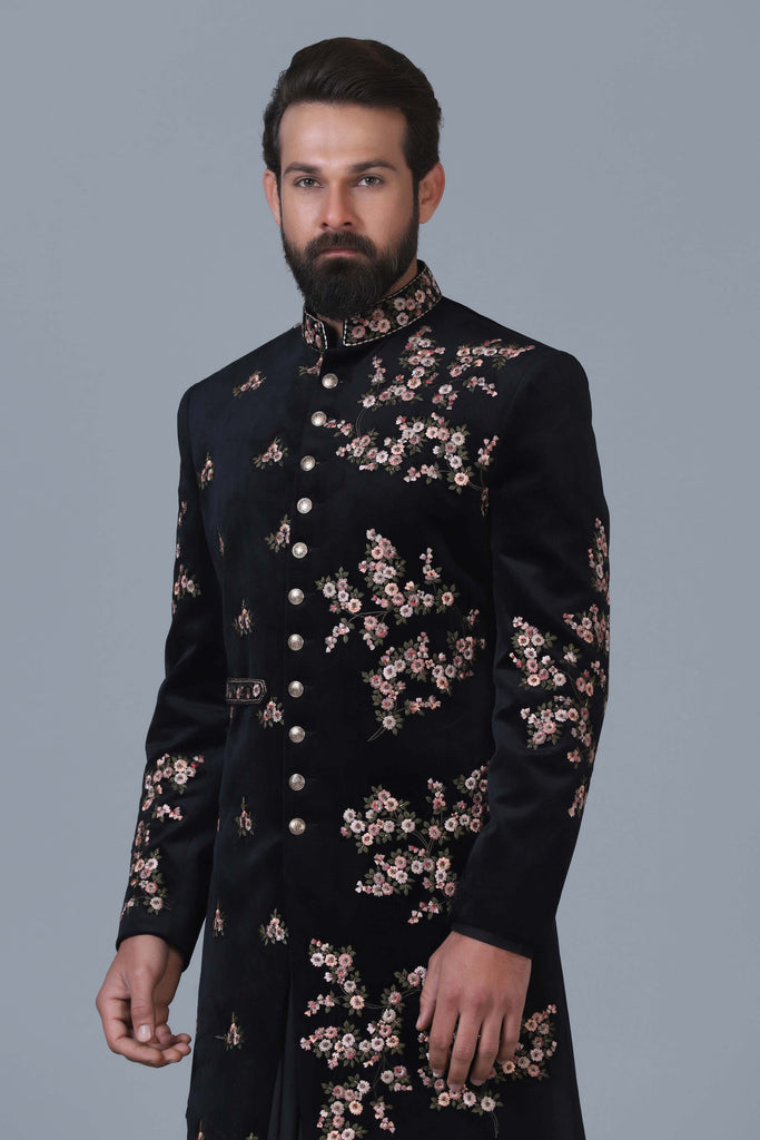 Exude sophistication in our black velvet Indowestern, adorned with intricate floral embroidery. Perfectly paired with a matching black kurta pajama set.