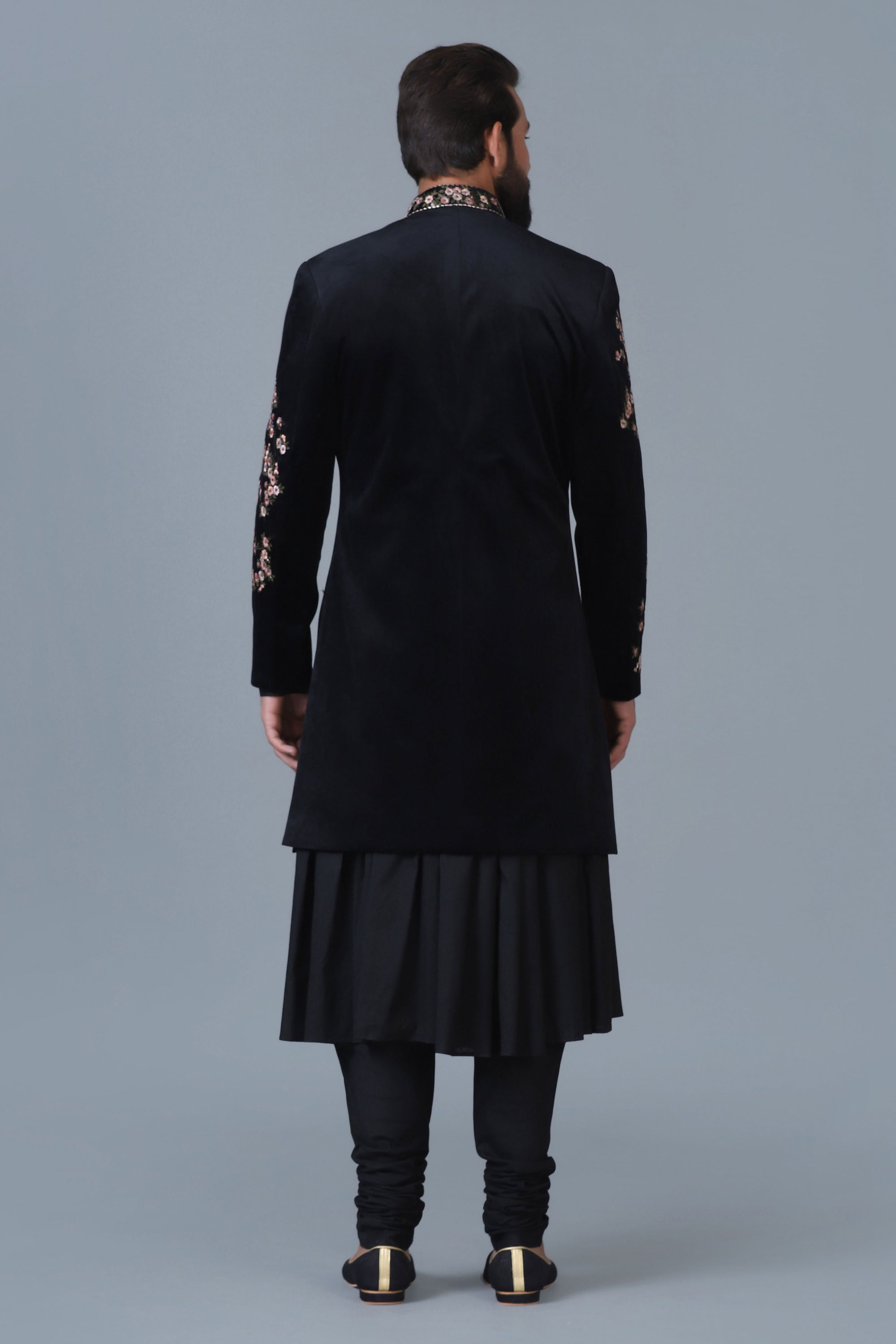 Exude sophistication in our black velvet Indowestern with intricate floral embroidery. Shop Now!