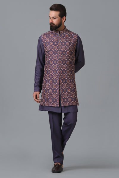 Elevate your ensemble with our long purple raw silk Nehru jacket, adorned with geometric embroidery. Pair it seamlessly with a coordinated purple kurta pajama set.