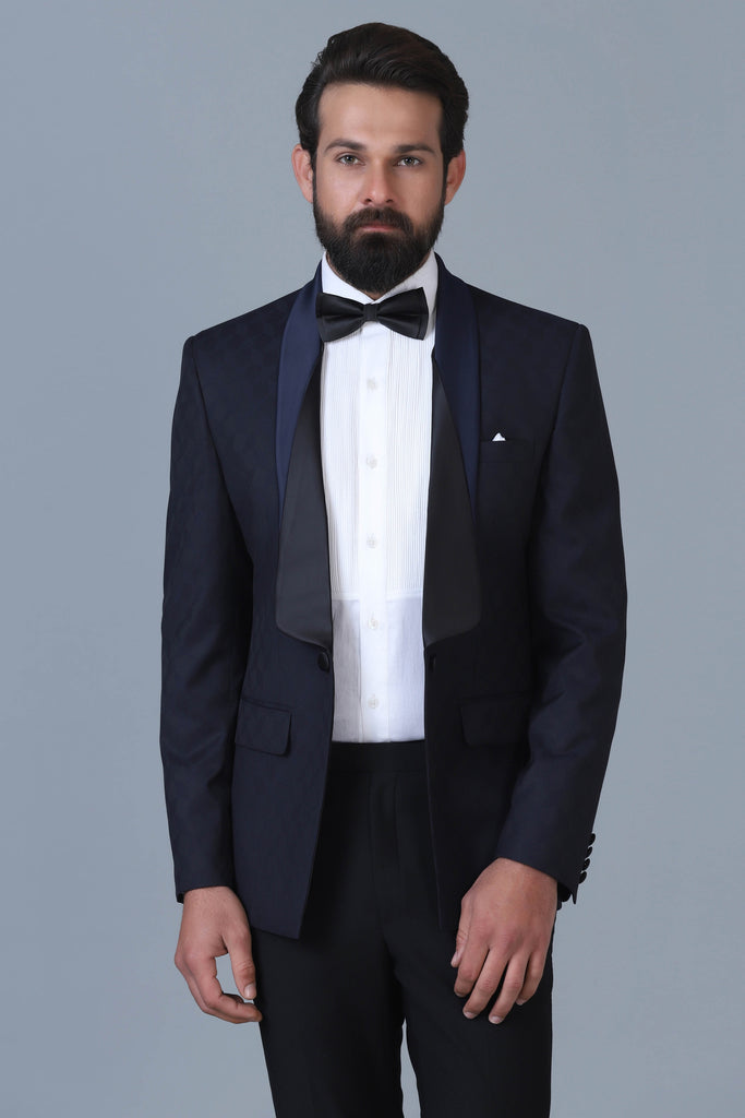 Elevate your style with our Designer Tuxedo in navy Jacquard wool-rich fabric. Layered shawl lapel adds sophistication. Paired with jet black trousers.