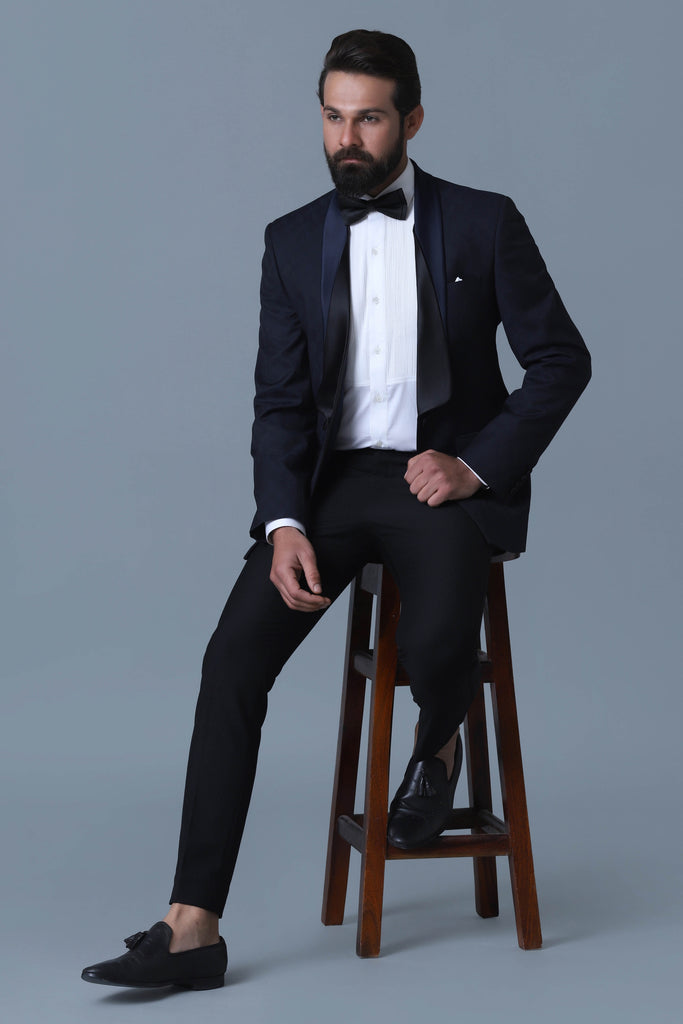 Elevate your style with our Designer Tuxedo in navy Jacquard wool-rich fabric. Layered shawl lapel adds sophistication. Paired with jet black trousers.