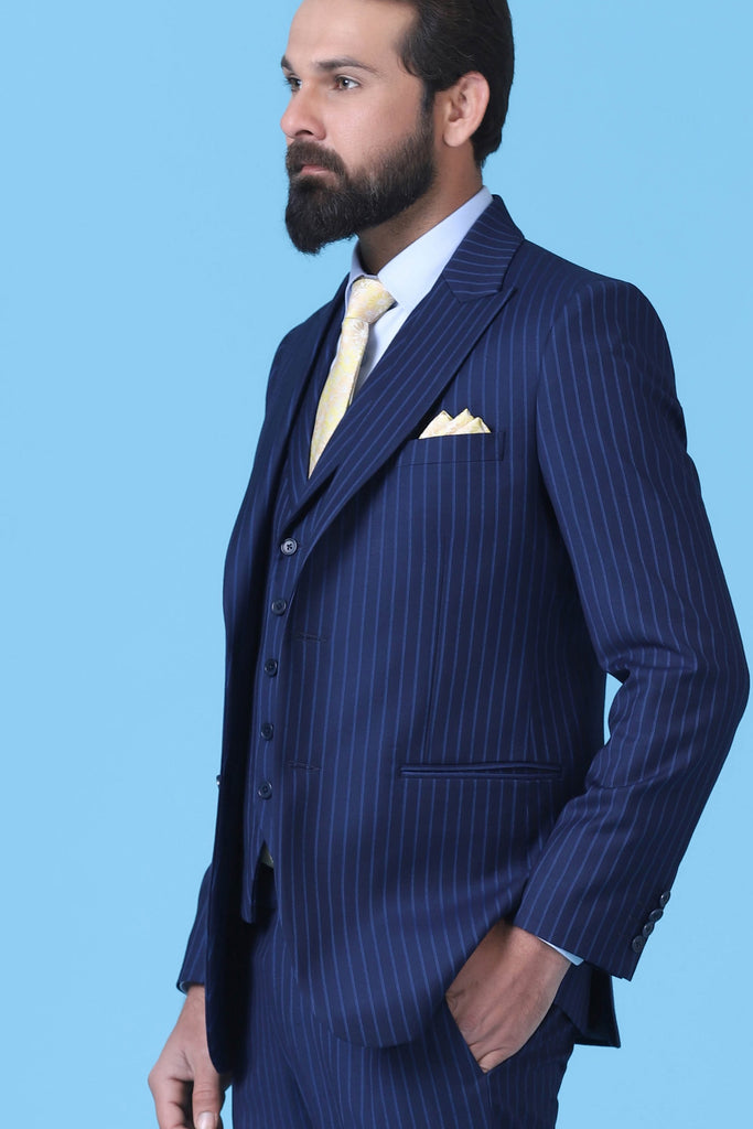 Elevate your style with our bold Pinstripe Suit. Crafted from Navy Blue Terry-Rayon Fabric, featuring a peak lapel and a 5-button Waistcoat.