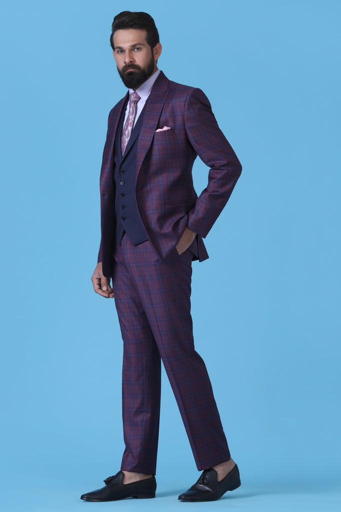 Step into elegance with our Dapper 3-Piece Suit. Super 130's Wool Fabric in wine check, paired with a navy Waistcoat for a refined look.