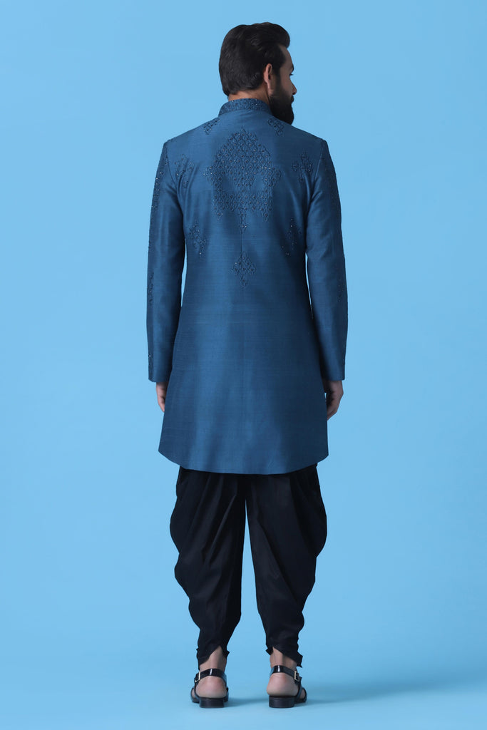 Elevate your ethnic look with this Teal Blue Indowestern, adorned with subtle geometric embroidery on the front and back. Paired with Black Cowl trousers for a sophisticated ensemble.