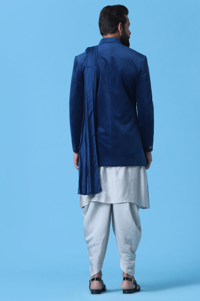 Make a statement in this Blue Velvet Indowestern featuring a stylish drape. Paired with a light grey Kurta and Cowl trouser, it exudes sophistication and style.