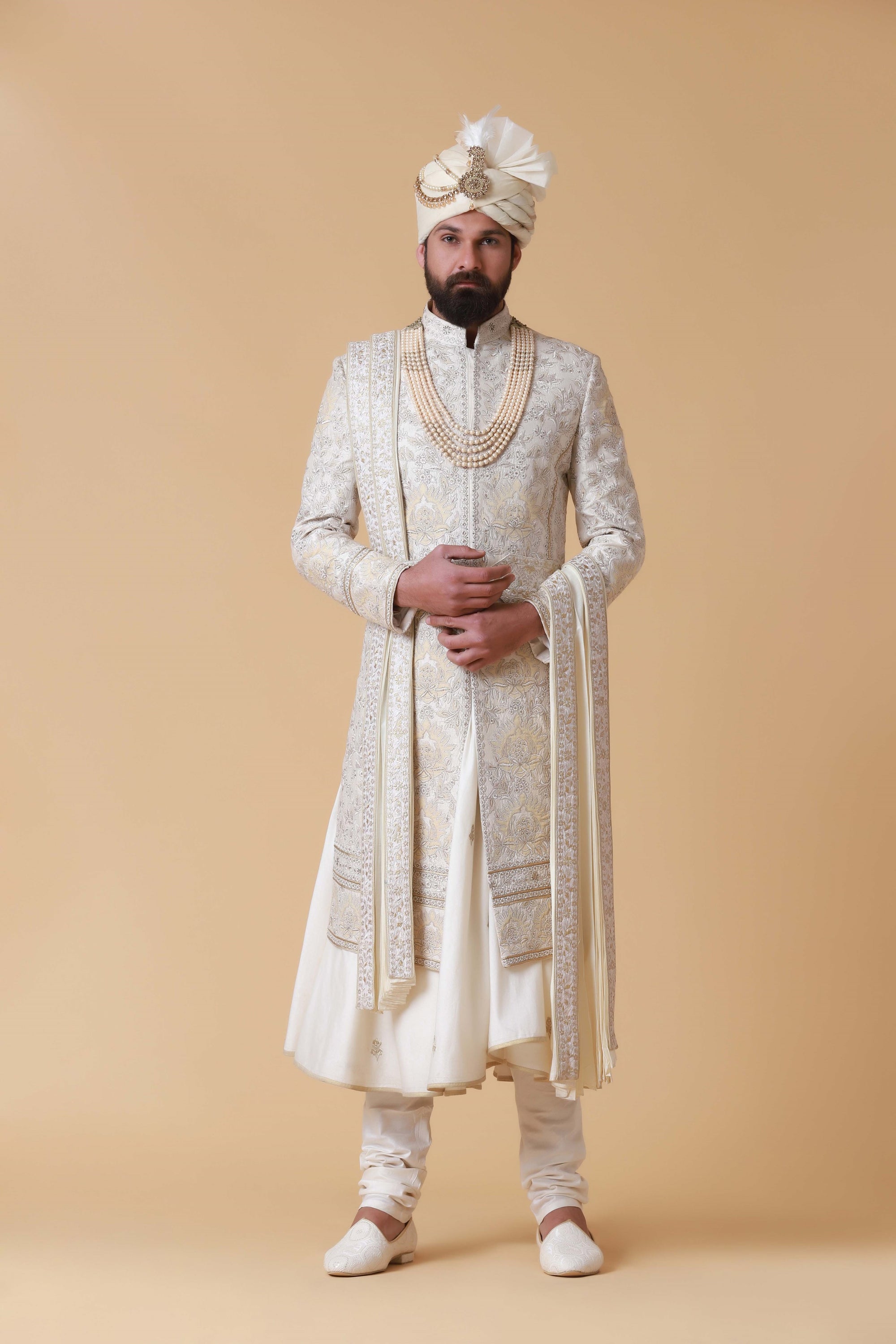 Exude regal elegance in this off-white Sherwani crafted from raw silk. Shop Now!