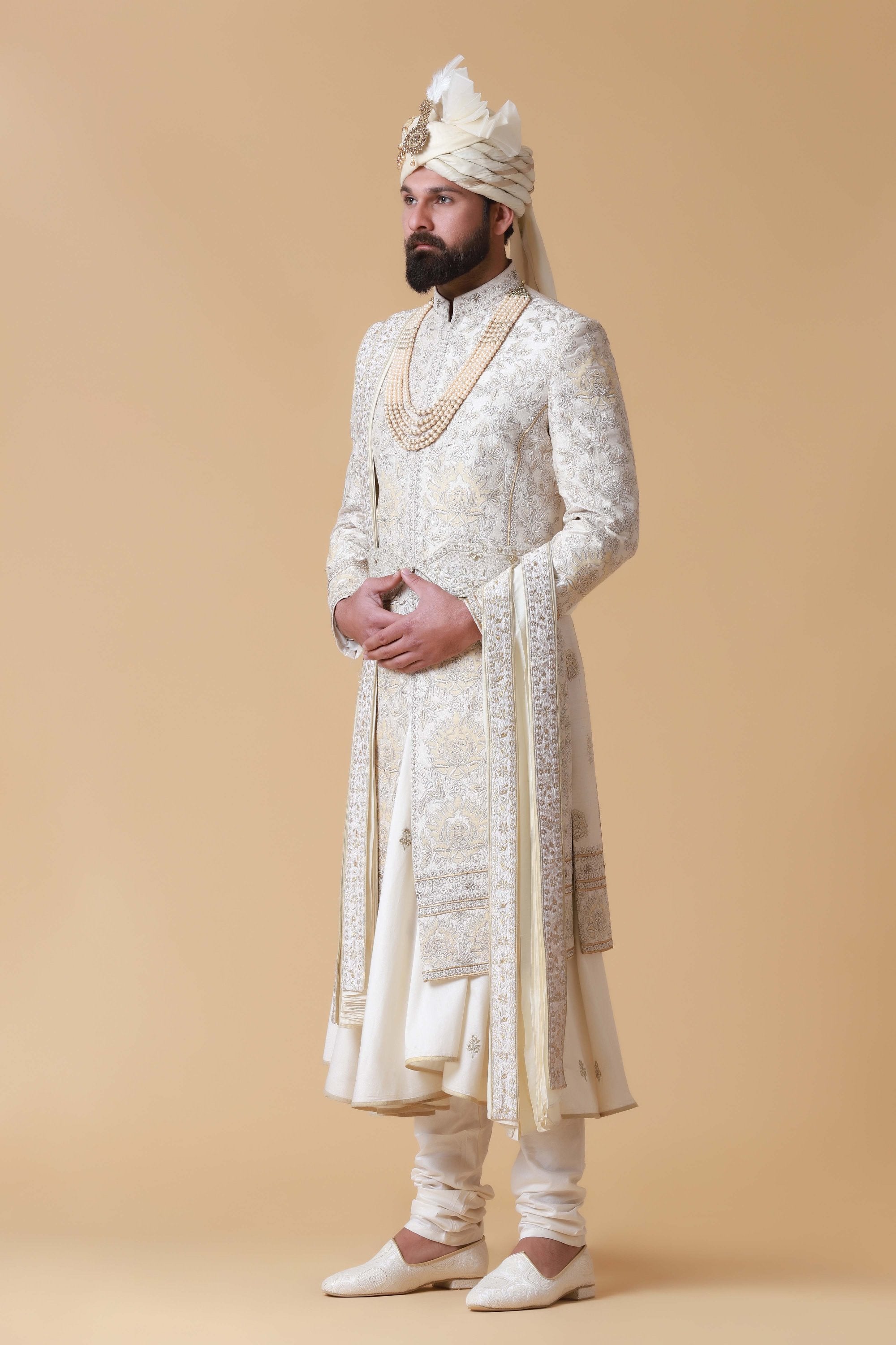 Exude regal elegance in this off-white Sherwani crafted from raw silk. Shop Now!
